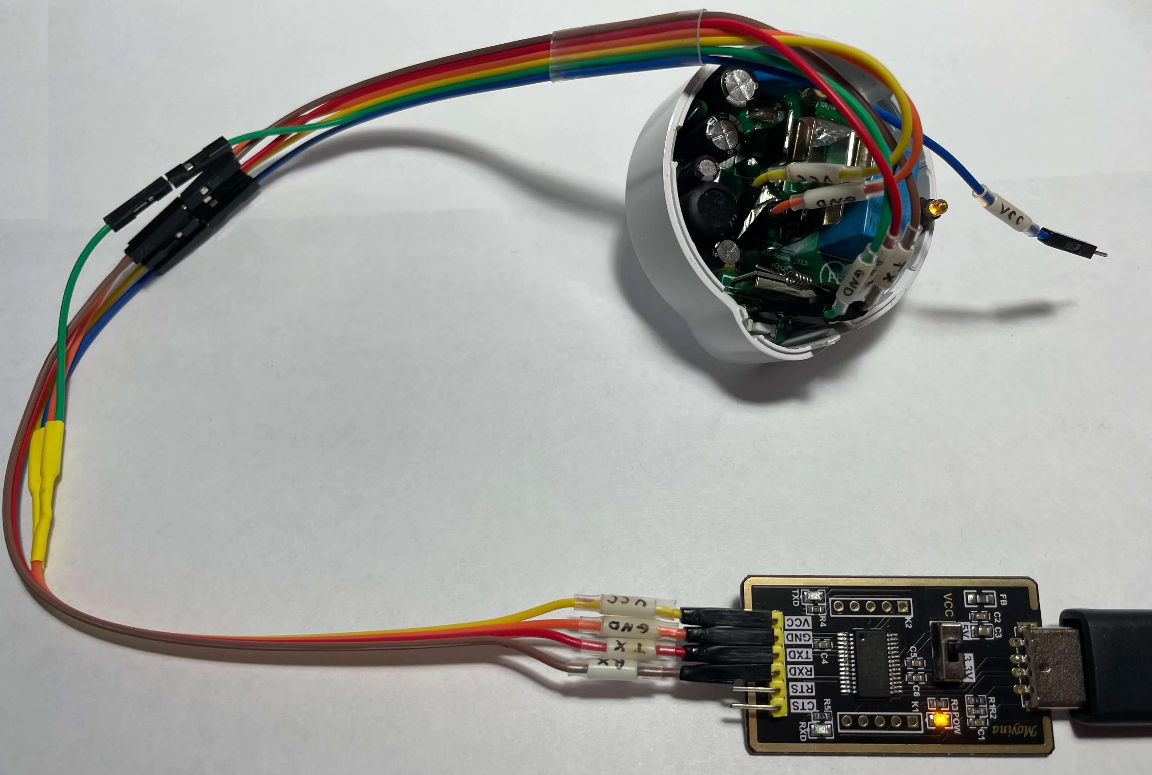 An angled view of the Etekcity Voltson ESW01-USA-R6P connected to a USB serial converter as described in the table above and booted into Flash Mode.